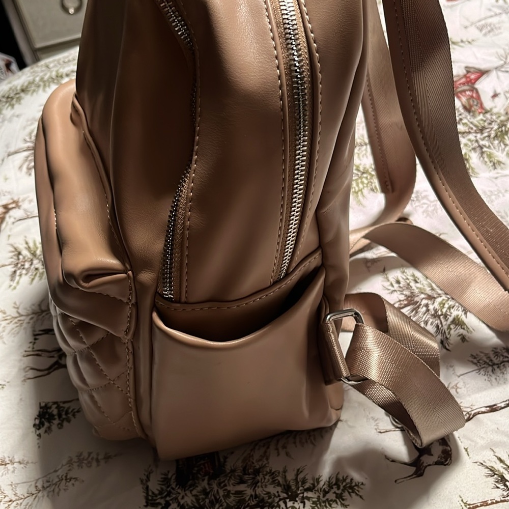 Tan backpack, purse, and very good shape used a few times